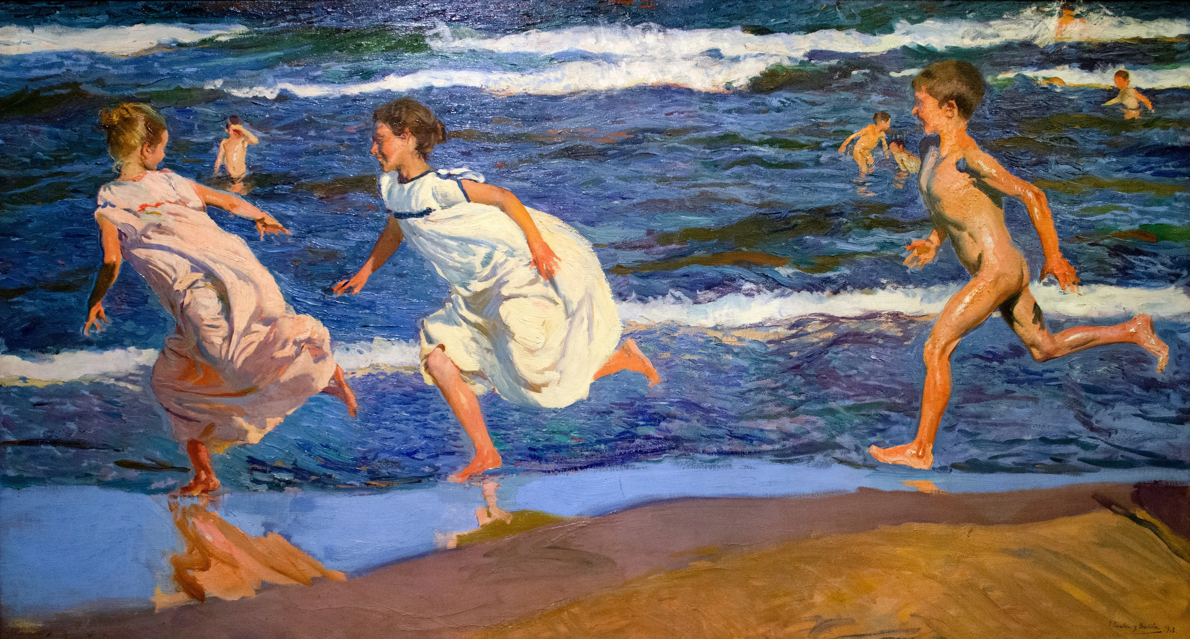 Children race barefoot along the surf's edge, bodies leaning into the run as sunlight and spray scatter across the wet, mirror-bright sand.